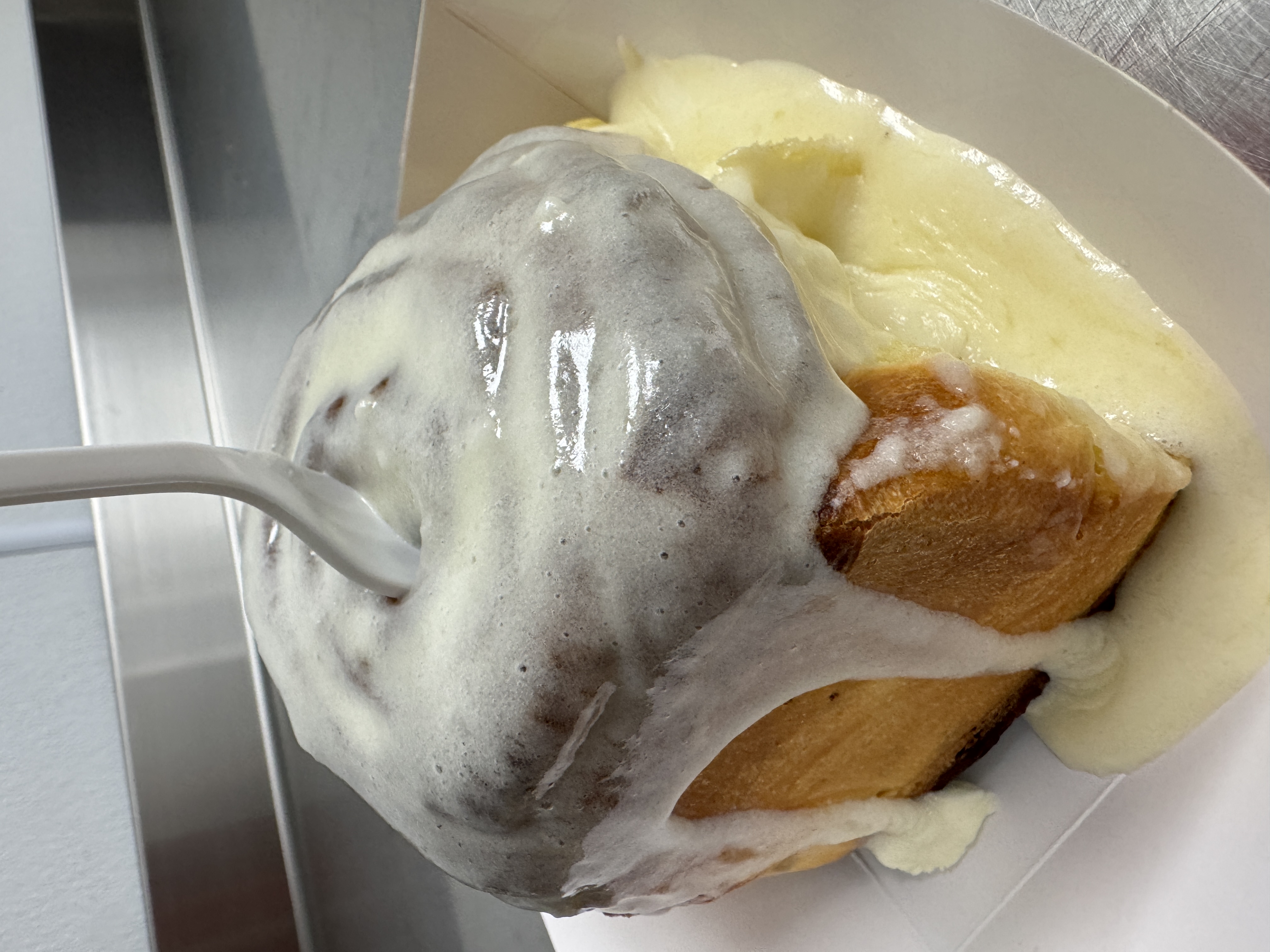 Warm glazed cinnamon roll from The Kolache Cafe